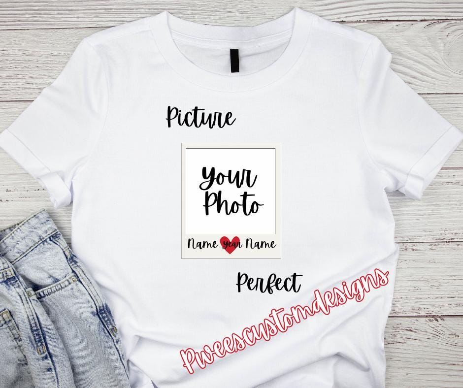 White t-shirt with customizable text and heart design on a wooden surface