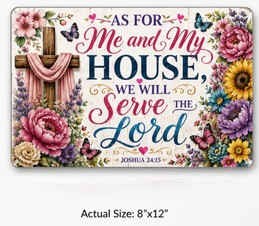 A rectangular decorative sign with a religious message reading 'AS FOR Me and My HOUSE, WE WILL Serve THE Lord' and 'JOSHUA 24:15,' surrounded by floral artwork and a wooden cross. The sign is shown on a light gray background with text below reading 'Actual Size: 8"x12"'.