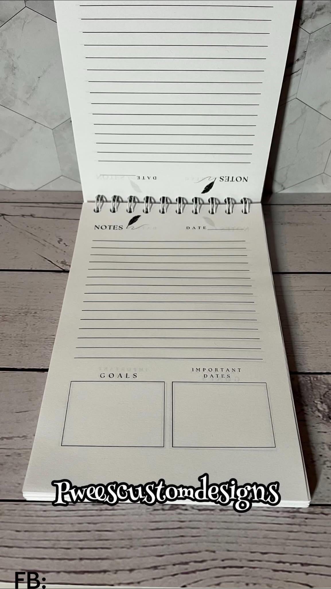 Notebook with lined pages and pre-printed sections on a wooden surface.