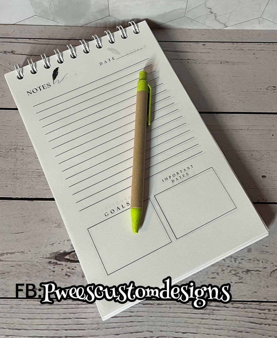 Notebook with pen on a wooden surface, featuring sections for notes, goals, and important dates.